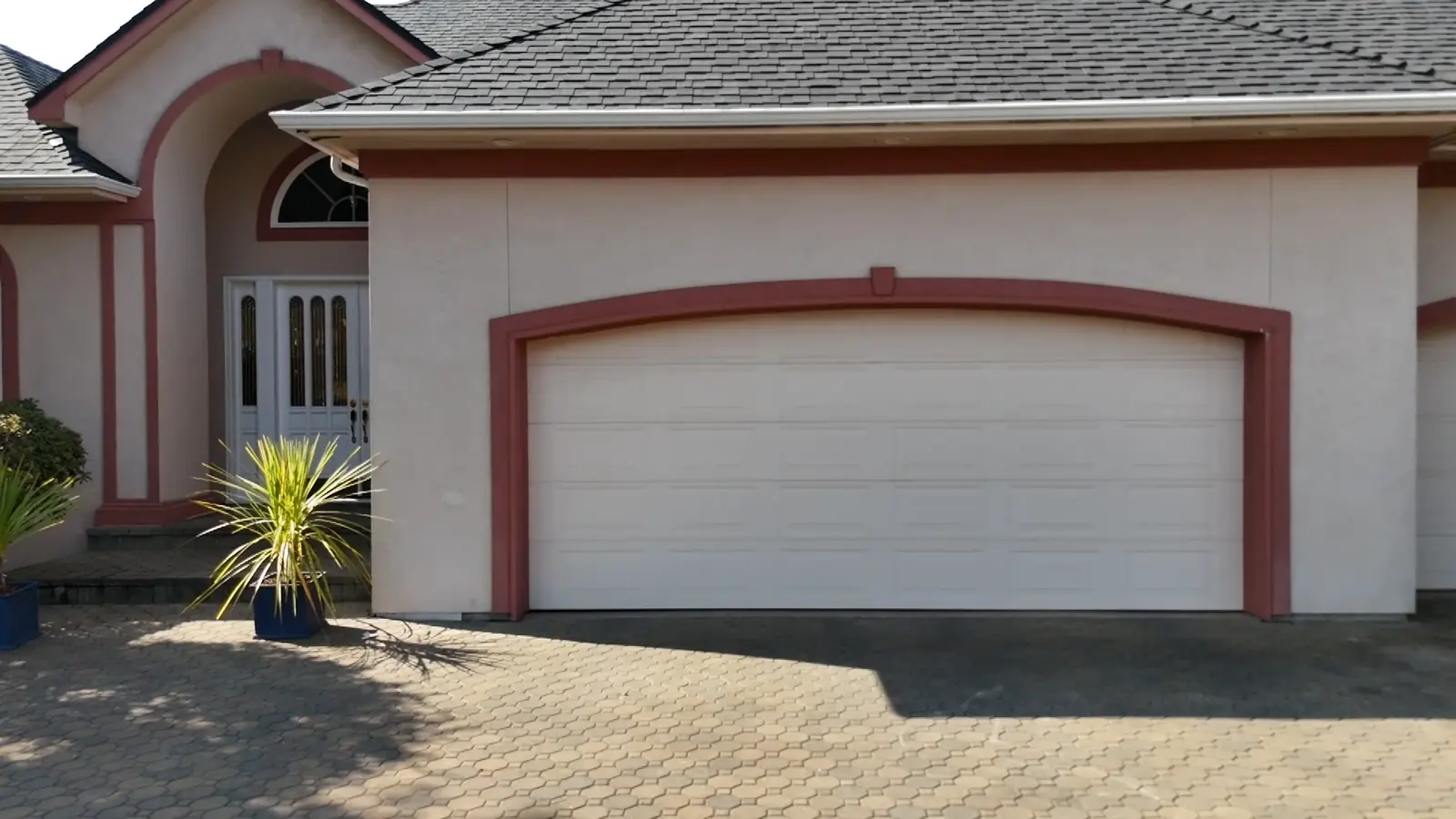 White garage wall with burgundy arched trim before painting