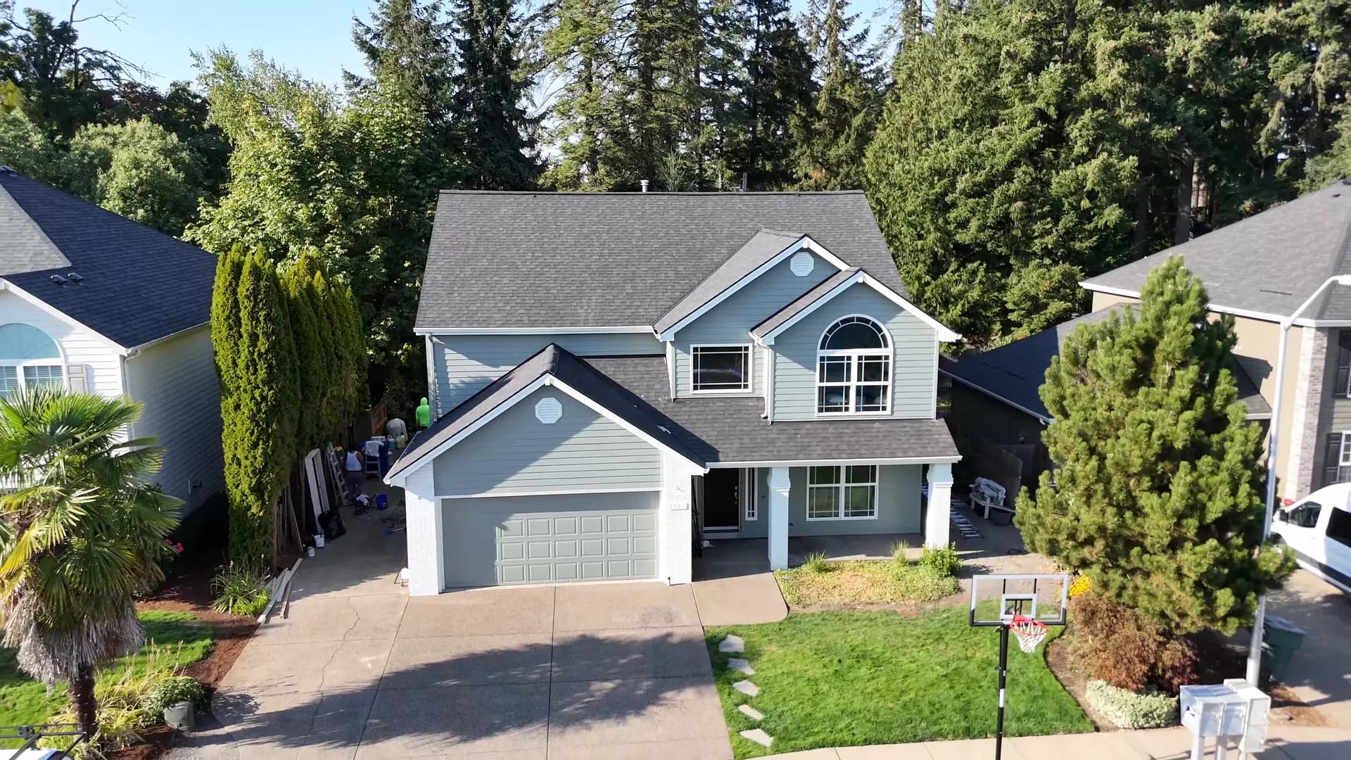 The sage green home from above the street