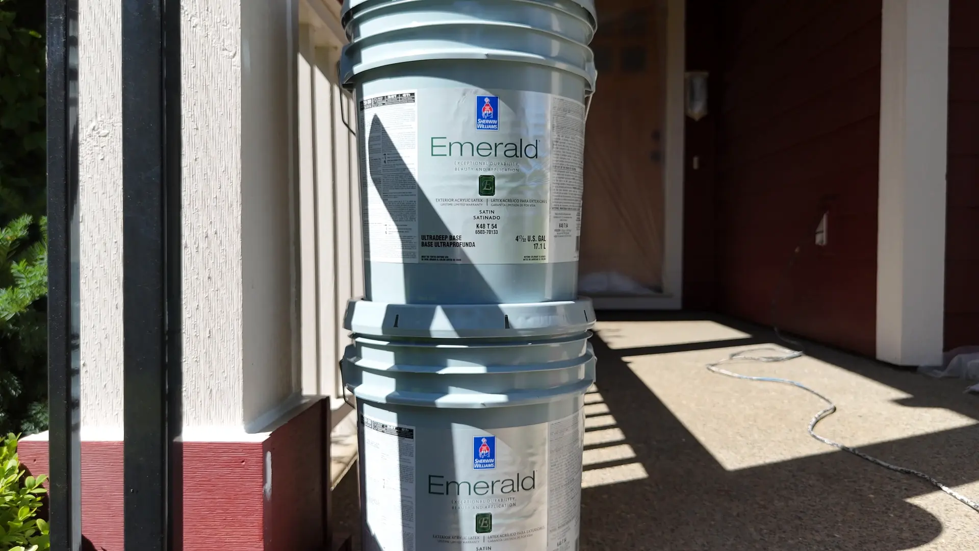 Sherwin-Williams Emerald exterior paint buckets on the porch