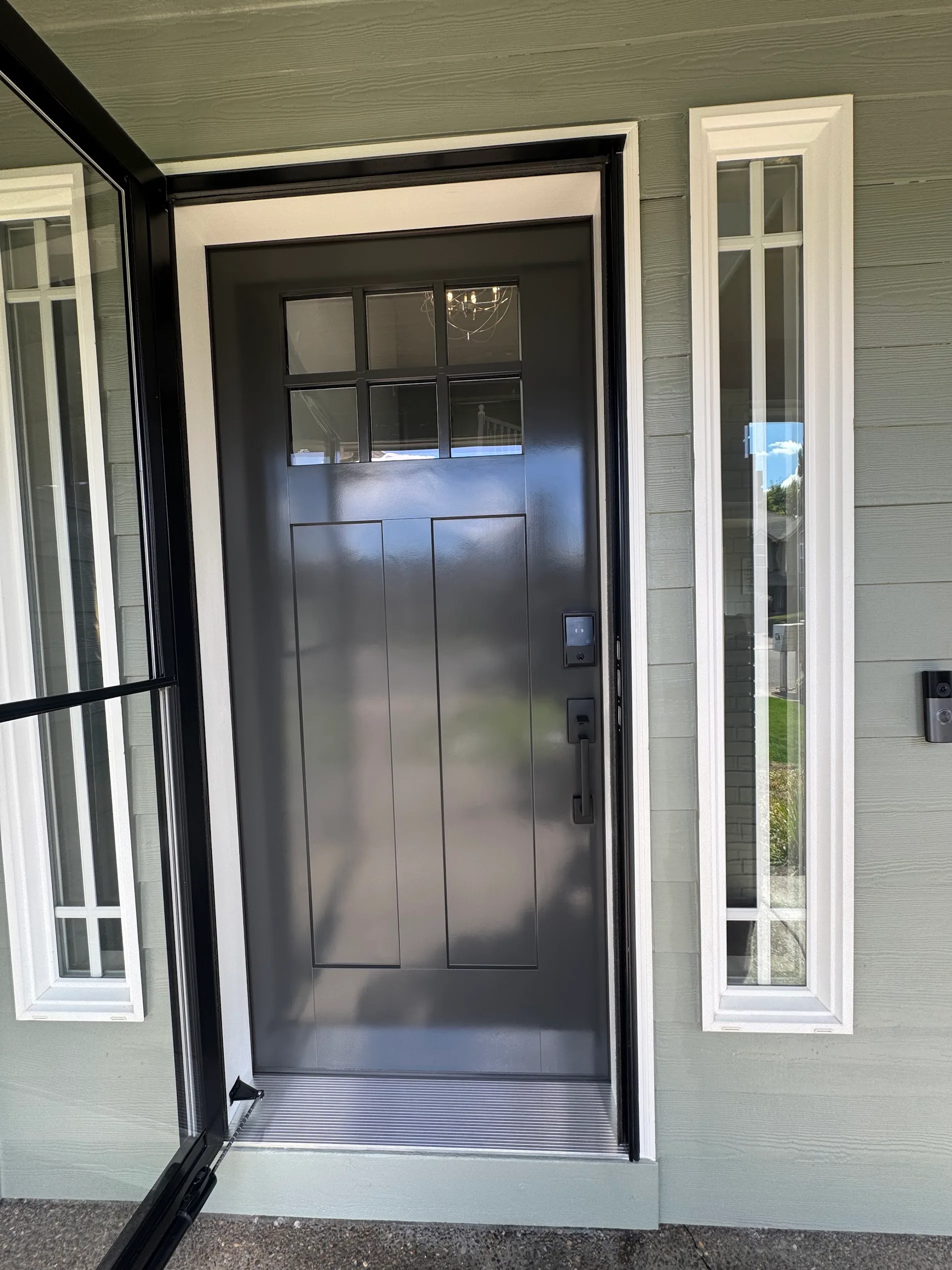 Craftsman front door finished in satin black with white trim and sidelights after painting