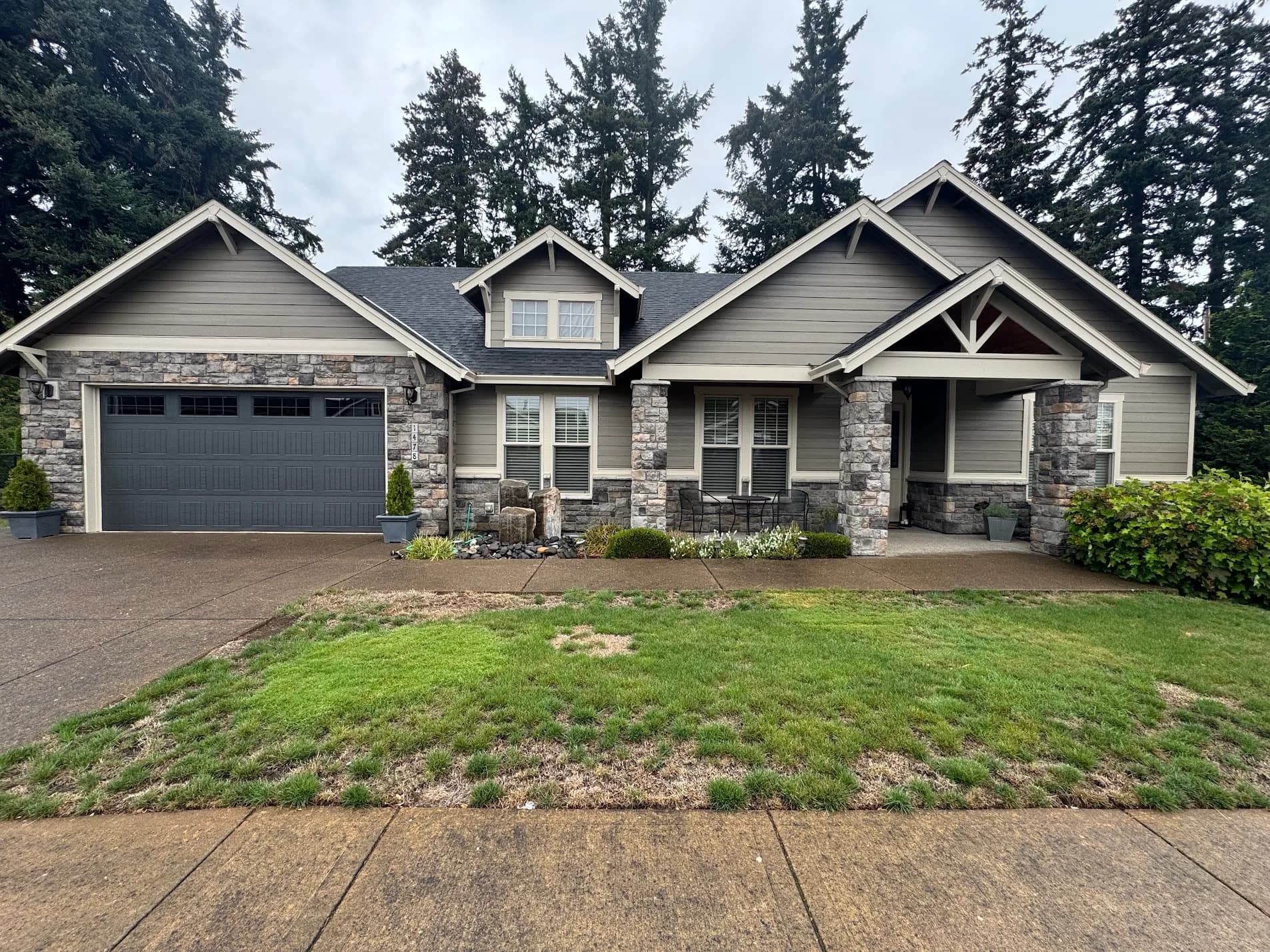 Craftsman home repainted in warm gray with cream trim and charcoal garage door, Woodburn Oregon
