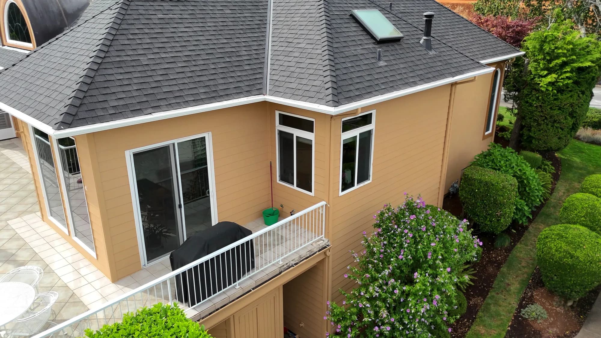 Upper side elevation and patio deck on luxury tan stucco home